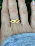 14K gold infinity ring with diamond accents, styled on hand