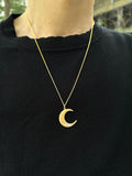 14K gold Lighting Moon Necklace with diamond-set crescent pendant worn on black top