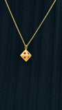 14K gold octagon necklace with ruby pendant styled on black ribbed top