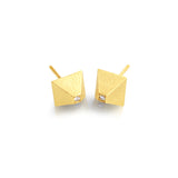 Pair of 14K gold pyramid earrings with diamonds, flat lay