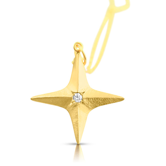 Close-up of white diamond set in gold star pendant