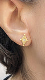 Model wearing 14K gold diamond shape earrings