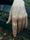 Close-up of the 14K Gold Double Arrow Aura Ring worn on hand, showcasing the unique twin-arrow design with white diamonds.