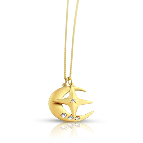 Close-up of 14K gold star and crescent moon pendant with white diamonds, matte finish on the Magical Star & Lighting Moon Necklace