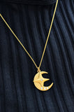 Model wearing the Magical Star & Lighting Moon Necklace — delicate 14K gold star and moon talisman resting gracefully at mid-chest